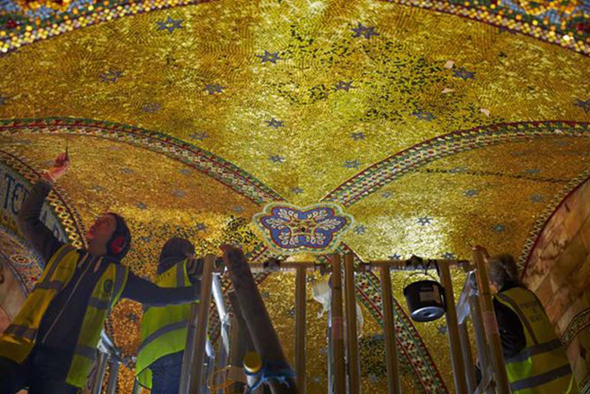 Restorers working on the golden ceiling of the Fitzrovia Chapel